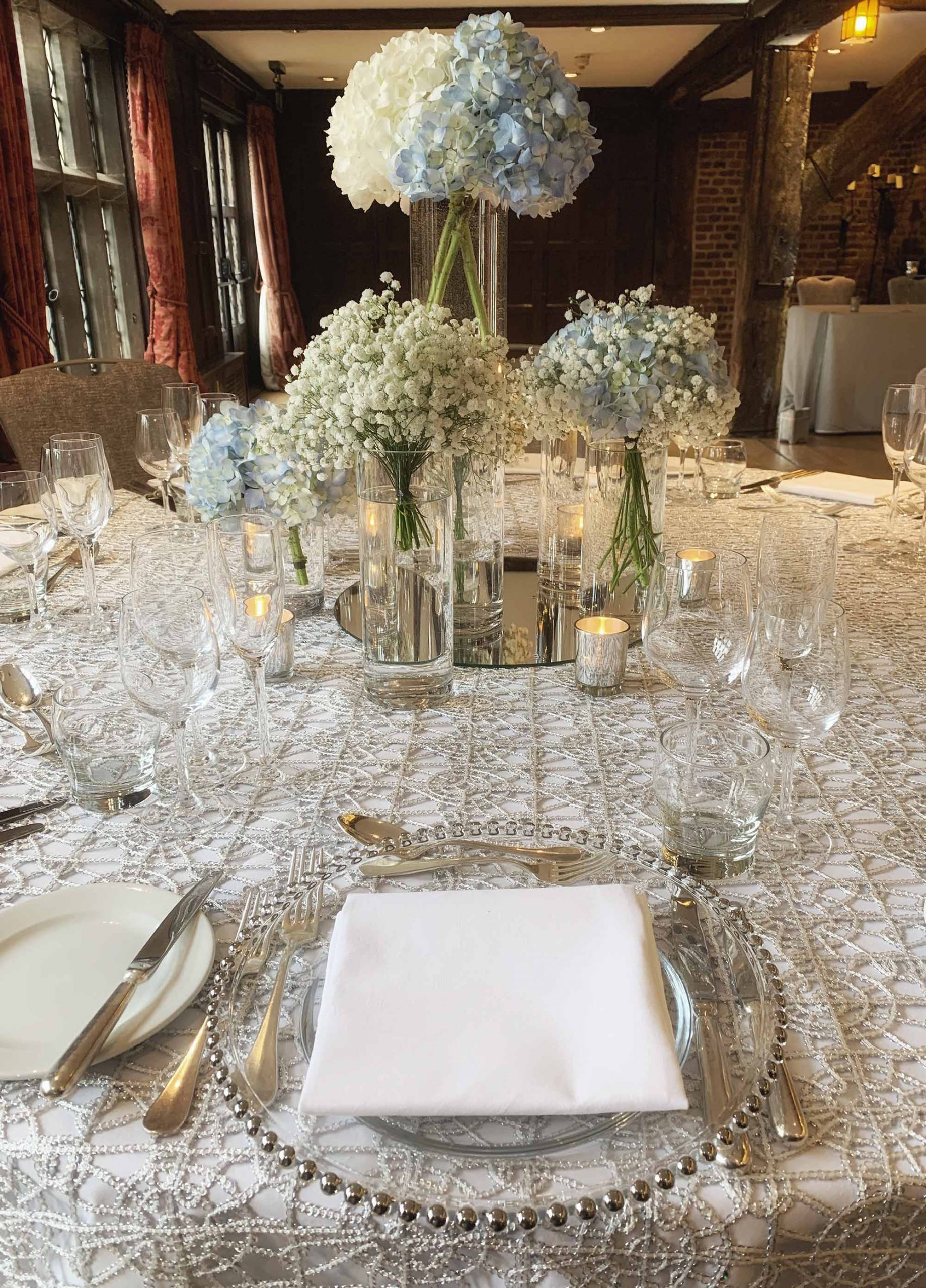 White chair covers and baby pink roses at Hampton Court Palace